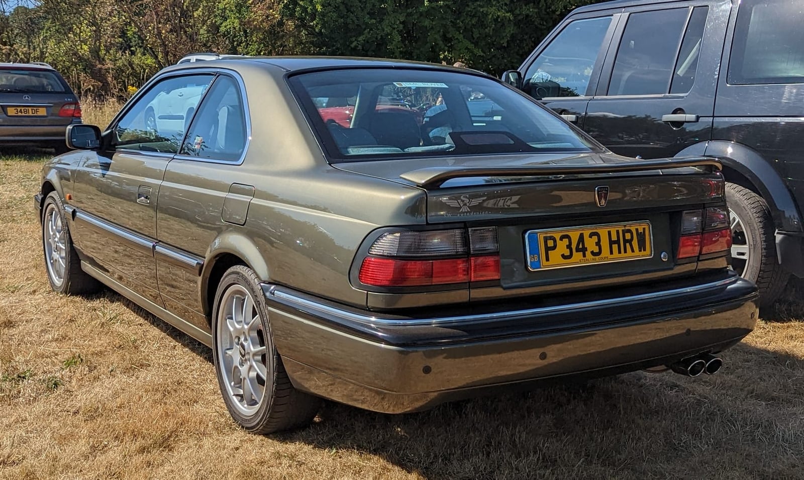 A champagne 1996 Rover 800 Sterling coupé with a UK registration on a show field